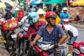 Drivers on a motorbike arrived at the street market