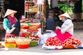 Vietnam, Phu Quoc Island, 26 February 2018: Smiling unidentified women with typical vietnamese conical hats sell fresh