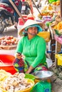 Vietnam, Phu Quoc Island, 26 February 2018: Unidentified women with typical vietnamese conical hats sell fresh food on a