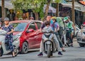 Vietnam street scene,little girl riding on motor scooter with dad with no crash helmet