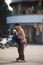 Vietnam, vietnamese man rides with roller skates Royalty Free Stock Photo