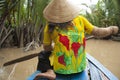 Vietnam woman with a paddle in boat, Mekong River