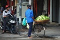 Vietnam woman people push bicycle cart hawker on road sale guava fruits to vietnamese people and foreign travelers on Hang Buom