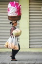 Vietnam women vendor hold basin basket on head walking on street sale local food product to vietnamese people and foreign traveler