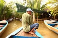 Vietnamese asian man rawing canoe boat