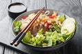 Vietnamese beef rice noodles salad with leafy vegetables, nuts and onions close-up in a bowl. horizontal Royalty Free Stock Photo