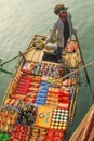 Vietnamese boy sells food on rowboat, Halong Bay Royalty Free Stock Photo
