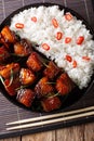 Vietnamese caramel pork with garnish of rice close-up on a plate