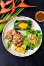 Vietnamese chicken boneless legs with baby corn under cheese, salad and grilled pineapple Royalty Free Stock Photo