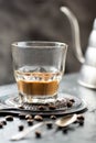 Vietnamese coffee with milk in a glass, silver spoon, coffee beans on a dark background Royalty Free Stock Photo