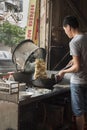 Vietnamese cook prepares a fried rice by the street