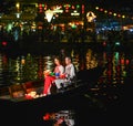 Vietnamese couple sitting on wooden boat