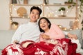 Vietnamese Couple Watching TV On Christmas Evening At Home Royalty Free Stock Photo