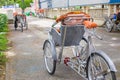 Ho Chi Minh City, Vietnam - September 1, 2018: Vietnamese cyclos and the shape of an undefined man in the back taking a break whil