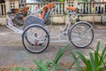 Ho Chi Minh City, Vietnam - September 1, 2018: Vietnamese cyclos and the shape of an undefined man in the back taking a break whil