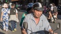 Vietnamese elderly man drives a motorbike