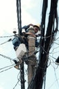 Vietnamese electricity worker climb high on electric post to repair electricity network