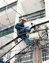 Vietnamese electricity worker climb high on electric post to repair electricity network