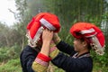 Vietnamese ethnic minority Red Dao women preparing traditional dress in bamboo forest in Lao Cai, Vietnam Royalty Free Stock Photo