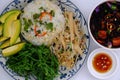 Vietnamese family meal for lunch with vegetarian food, vegetables, avocado with sauce, seaweed soup, vegan dish for dieting