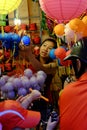 Vietnamese family on motorbike shopping mid autumn toy at night lantern street