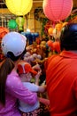 Vietnamese family on motorbike shopping mid autumn toy at night lantern street