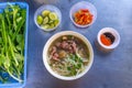 Vietnamese famous dish, Pho beef noodle soup and vegetables Royalty Free Stock Photo