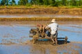 Vietnamese farmer prepares drowned field for rice sowing