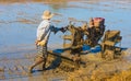 Vietnamese farmer prepares field for rice sowing