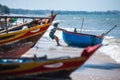 Vietnamese fisherman are pulling his fishing coracle out to the sea for his break time at Fisherman