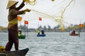 Vietnamese fisherman fishing with net