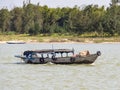 Vietnamese fishermen on a boat catching fish, Mekong river delta area