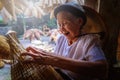 Vietnamese fishermen are doing basketry for fishing equipment at Royalty Free Stock Photo