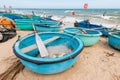 Vietnamese fishing coracles on beach, tribal boats at fishing vi