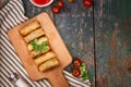 Vietnamese food. Delicious homemade spring rolls on wooden table