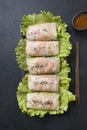 Vietnamese food spring rolls with vegetables, shrimps in rice paper on black stone background. View from above. Asian cuisine. Royalty Free Stock Photo