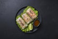 Vietnamese food spring rolls with vegetables, shrimps in rice paper on black. View from above. Asian cuisine Royalty Free Stock Photo