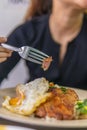 Vietnamese girl eating Com tam - a Vietnamese broken rice with pickles steak grilled pork ribs cucumber onion oil sweet chilies Royalty Free Stock Photo