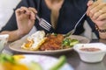 Vietnamese girl eating Com tam - a Vietnamese broken rice with pickles steak grilled pork ribs cucumber onion oil sweet chilies Royalty Free Stock Photo