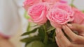 Vietnamese girl holding a bouquet of pink roses