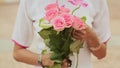 Vietnamese girl holding a bouquet of pink roses