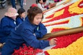 Vietnamese girl puts a festive installation of artificial flowers