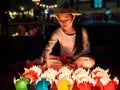 Vietnamese Girl Selling Candle Offerings in Hoi An, Vietnam