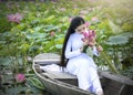 Vietnamese girl in traditional long dress or Ao Dai inside boat