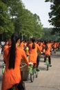 Vietnamese girls wear traditional long dress Ao Dai cycling on Hanoi street Royalty Free Stock Photo