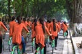 Vietnamese girls wear traditional long dress Ao Dai cycling on Hanoi street Royalty Free Stock Photo