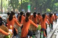 Vietnamese girls wear traditional long dress Ao Dai cycling on Hanoi street Royalty Free Stock Photo