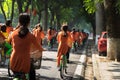 Vietnamese girls wear traditional long dress Ao Dai cycling on Hanoi street Royalty Free Stock Photo