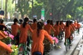 Vietnamese girls wear traditional long dress Ao Dai cycling on Hanoi street