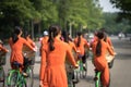 Vietnamese girls wear traditional long dress Ao Dai cycling on Hanoi street